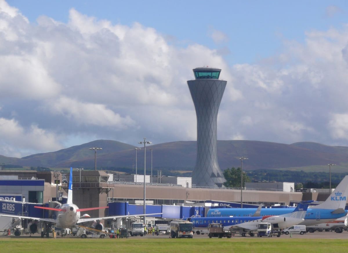 Edinburgh Airport control tower and terminal with the Pentland Hills behind